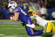 Adrian Amos #31 of the Green Bay Packers tackles Dawson Knox